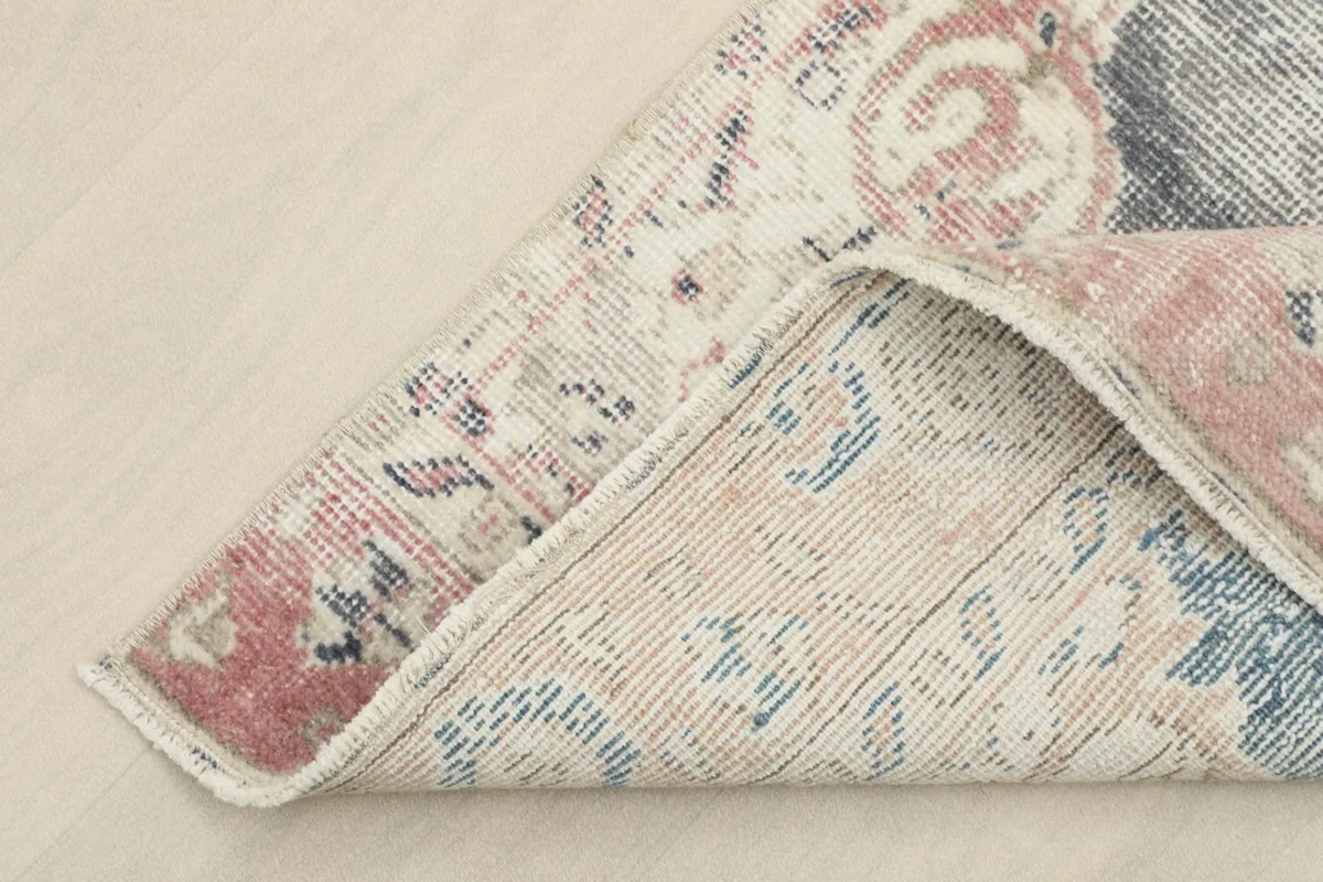 View of the back of the rug, showing the cotton foundation and tight hand-knotting