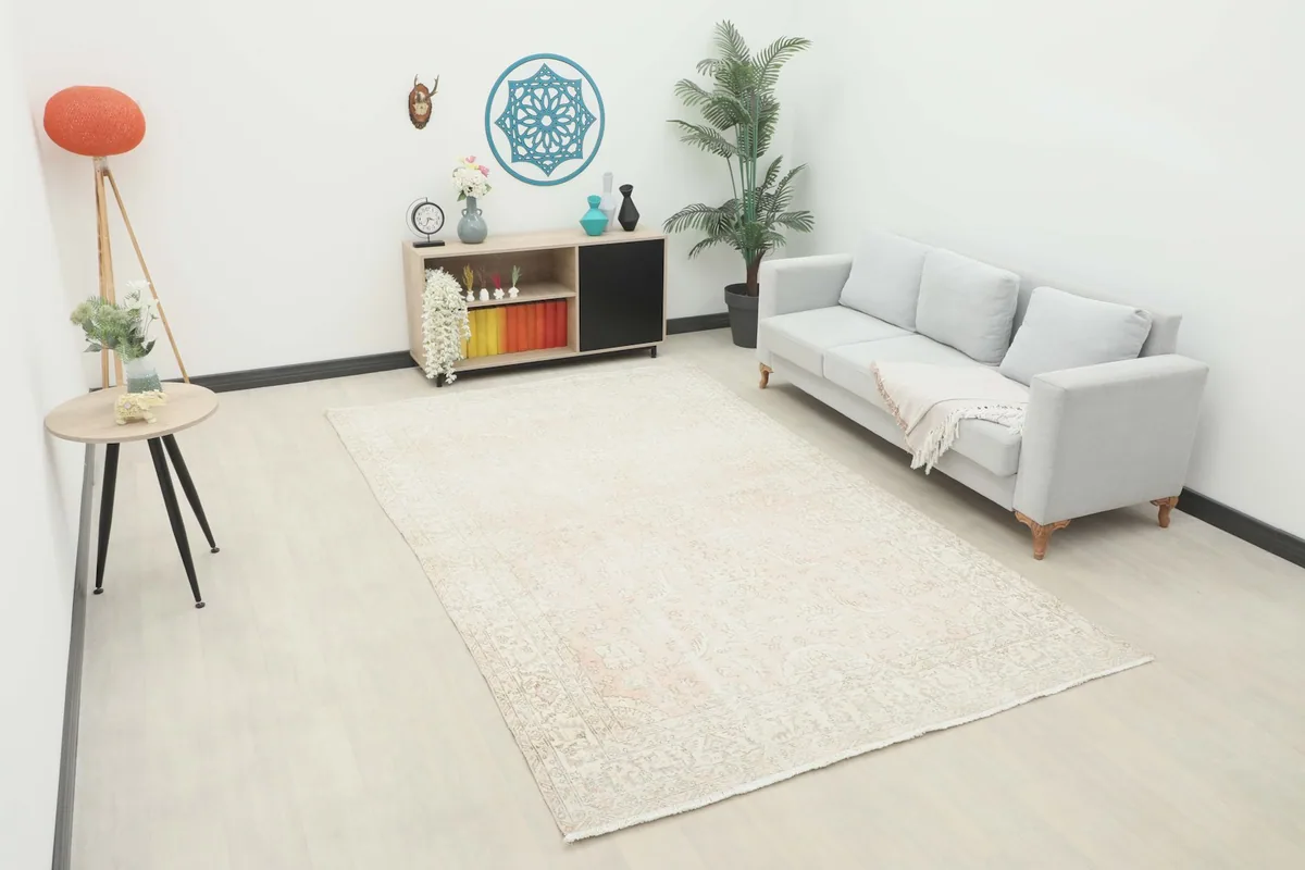 Vintage Anatolian rug displayed in a living room setting with a light gray sofa