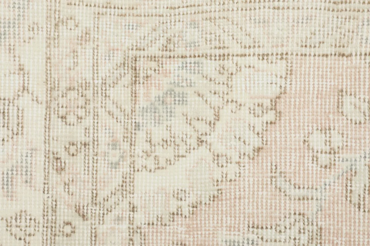 Close-up of the low wool pile and subtle color variations within the rug's pattern
