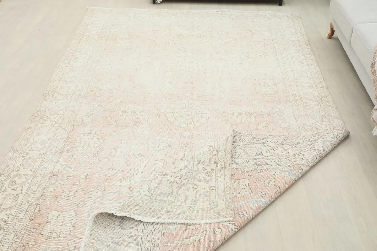 Large rug with a corner folded back, demonstrating its flexibility and construction
