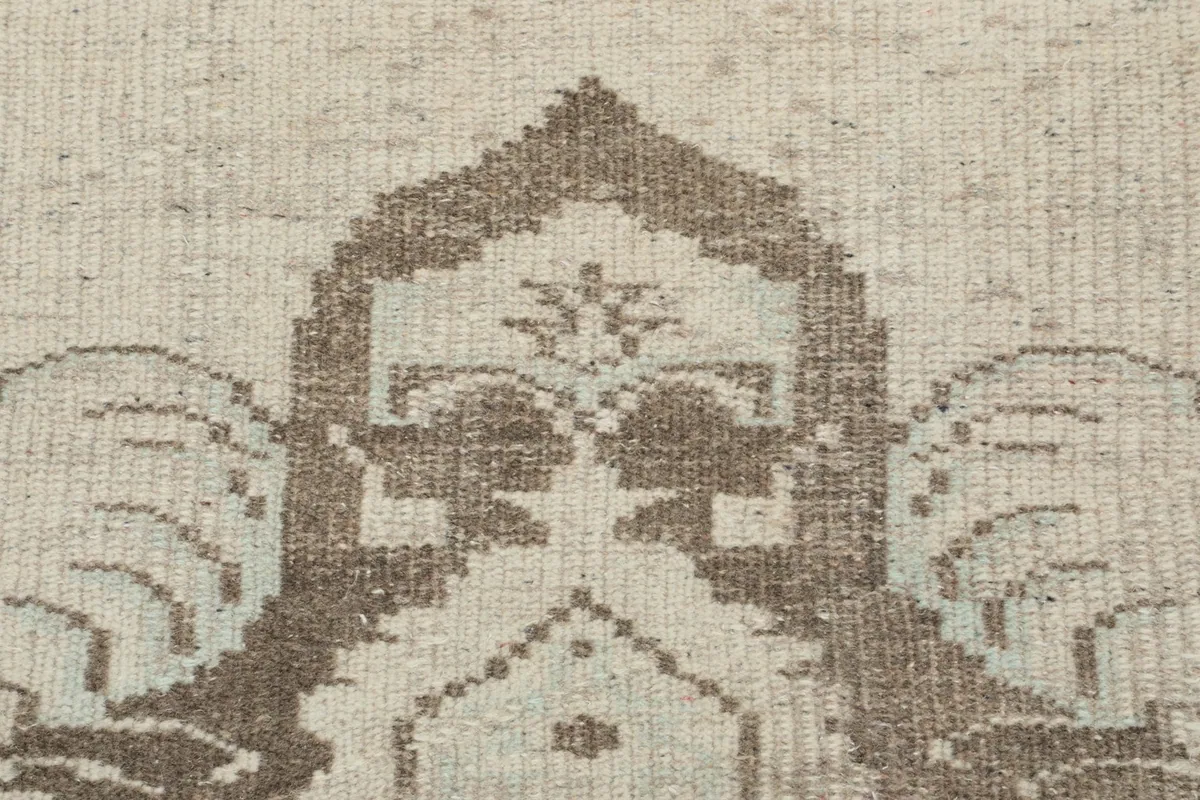 Close-up showing the low pile and texture of the hand-knotted wool on the rug