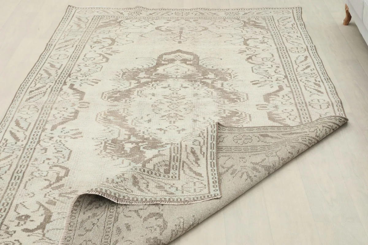 View of the back of the rug and a partially folded corner, revealing the construction