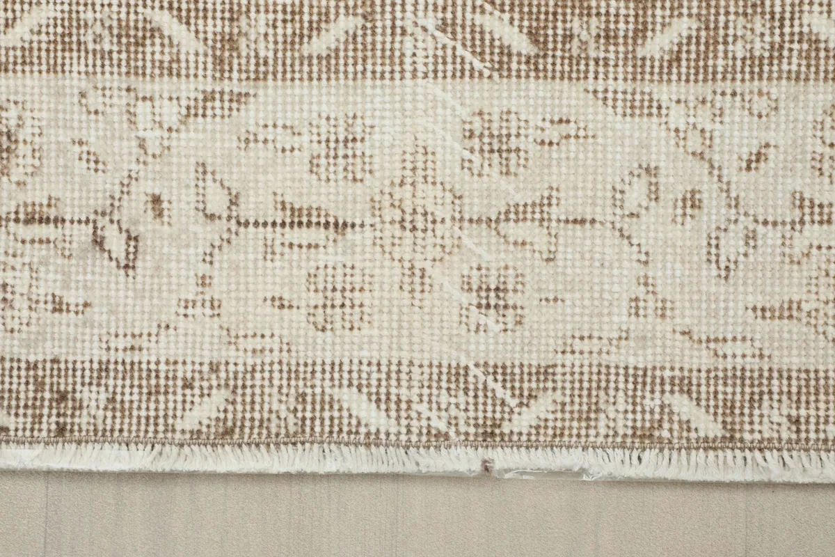 Detailed view of the outer border design and short fringes of the vintage Anatolian rug