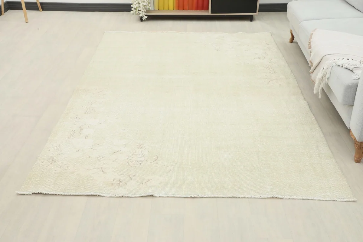 Full view of the cream vintage rug in a living space, anchoring the room