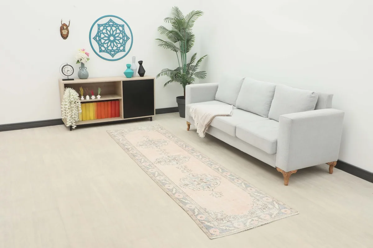 Runner rug displayed in a living room setting with a light gray sofa and wooden cabinet.