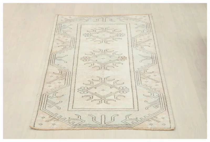 Full top view of the cream and charcoal tribal geometric vintage Anatolian rug