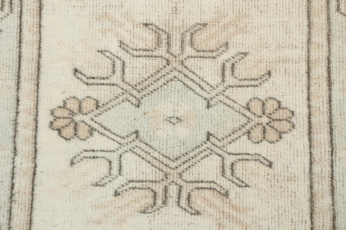 Close-up of a central medallion-like geometric motif with floral accents