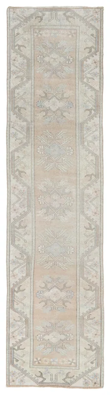 Full top view of the vintage beige and gray Anatolian runner rug on a white background