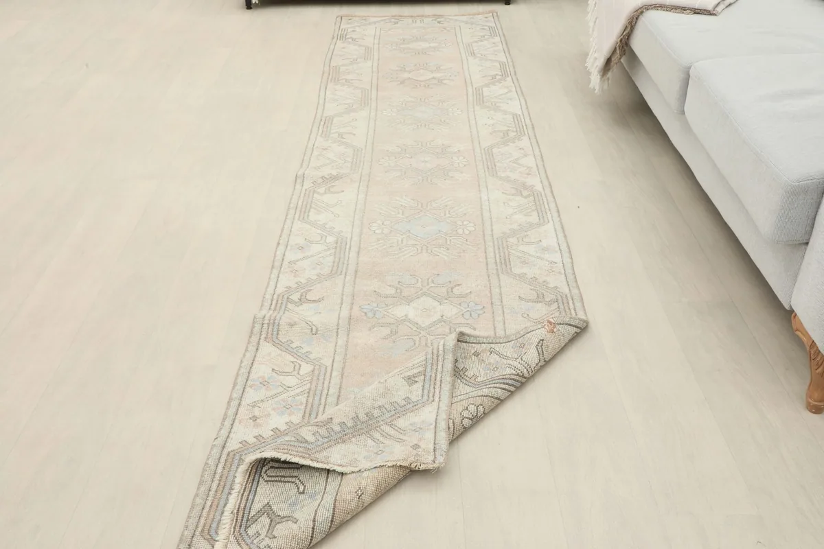The runner rug with one end folded back, displaying the full length in a room setting
