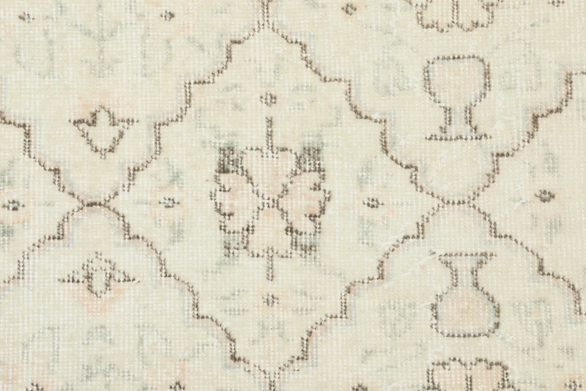 Close-up of the hand-knotted wool pile and the intricate floral and geometric designs