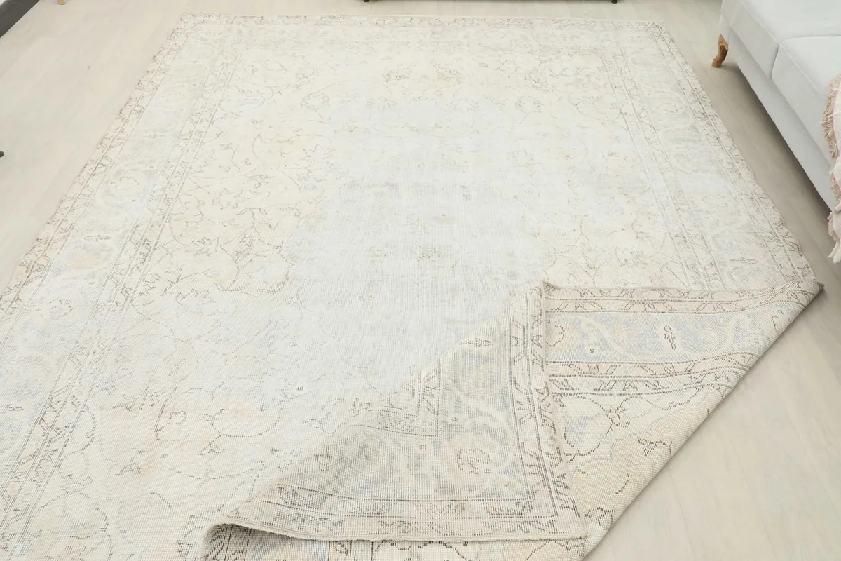 Full view of the rug laid out, with a corner gently folded to show the thickness and back
