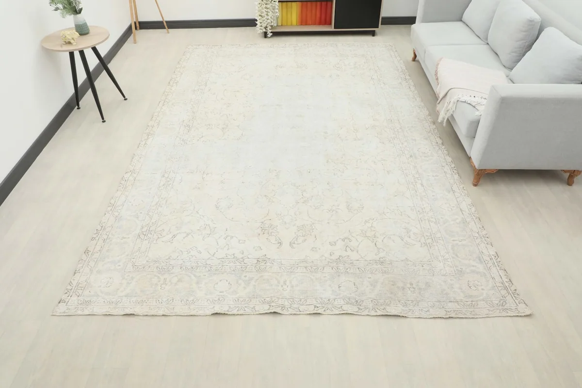 Wide view of the large ivory rug in a living room, providing a sense of scale and placement