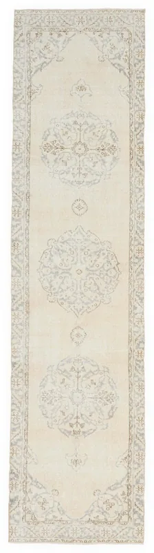 Full overhead view of the 2'8" x 11'1" ivory, cream, gray, and tan vintage Anatolian runner rug.