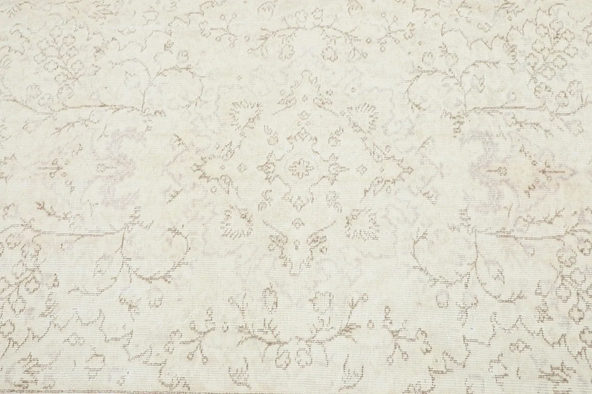 Detailed overhead view of the rug's central floral medallion and surrounding motifs.