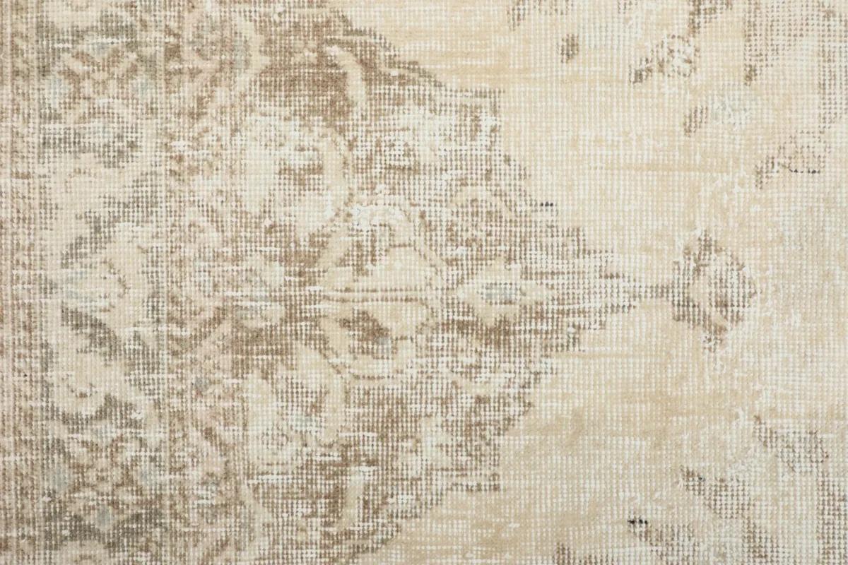 Detailed view of the distressed texture and intricate patterns in the rug's pile