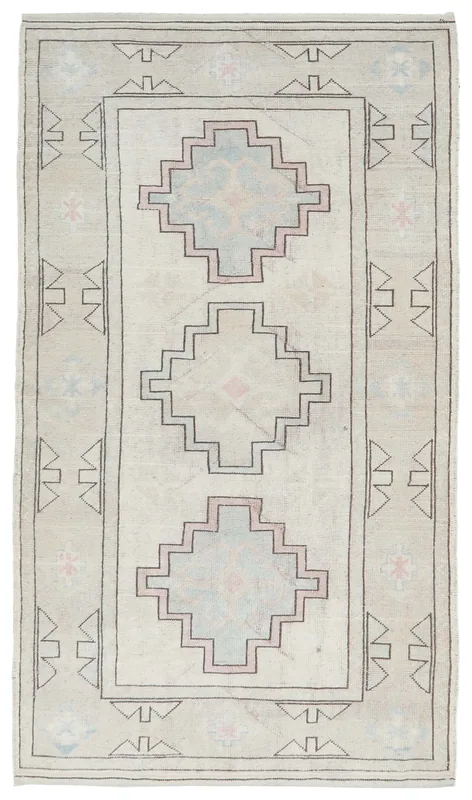 Full top view of the 4'1" x 7'5" ivory and beige geometric Anatolian rug on a white background.