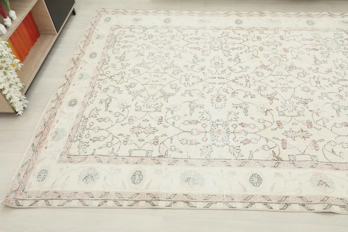 Side angle of the large rug, highlighting the soft color palette and hand-knotted texture.