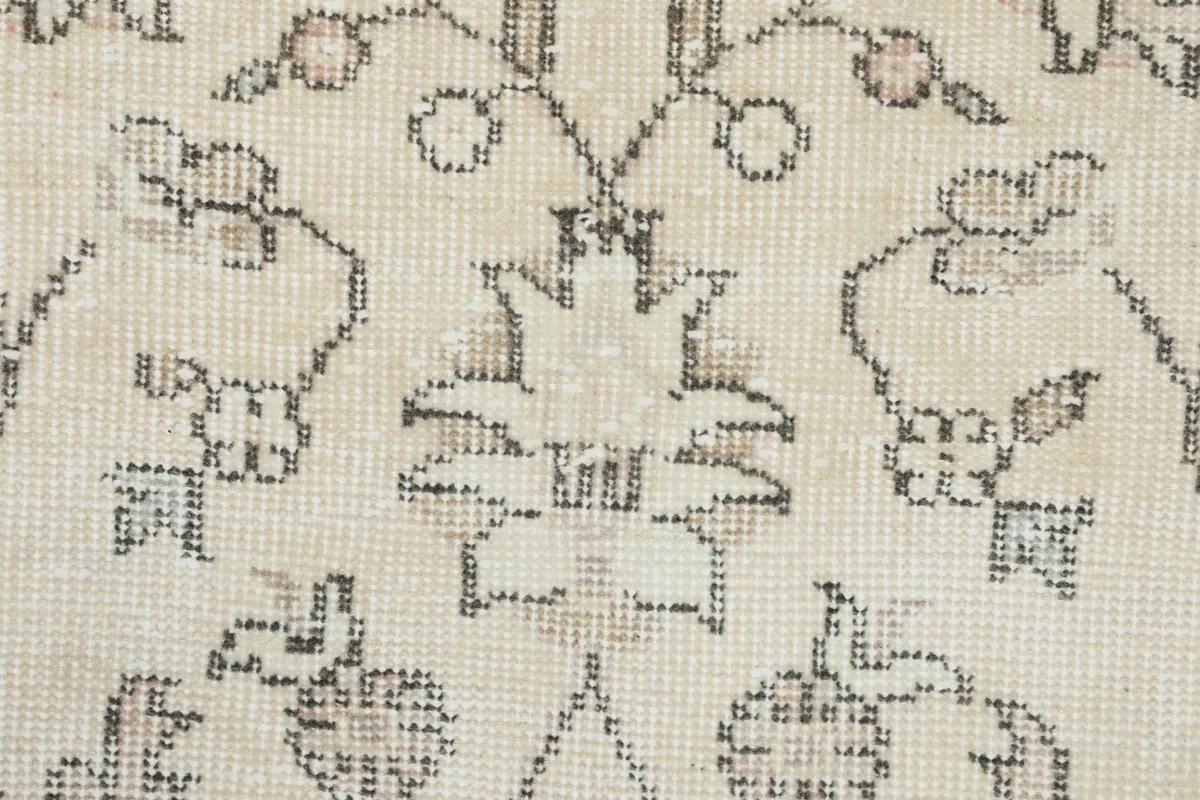 Close-up of the low pile and intricate knotting of the wool fibers, revealing color variations.