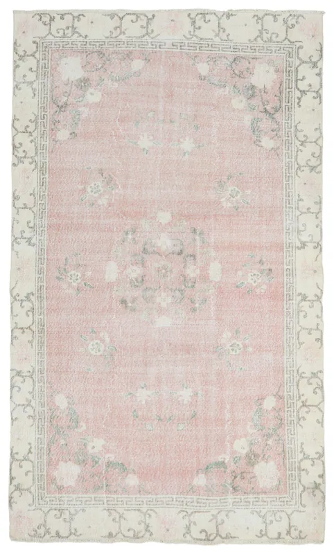 Full top view of the 6'4" x 10'6" vintage pink floral Anatolian rug on a white background.