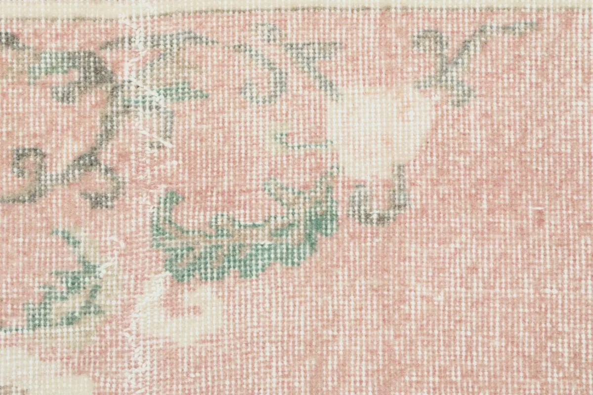 Detailed view of the low wool pile and the hand-knotted texture of the vintage rug.