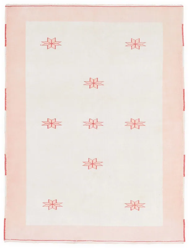 Full top view of the 4'10" x 6'5" ivory and pink vintage Anatolian rug with red geometric stars.