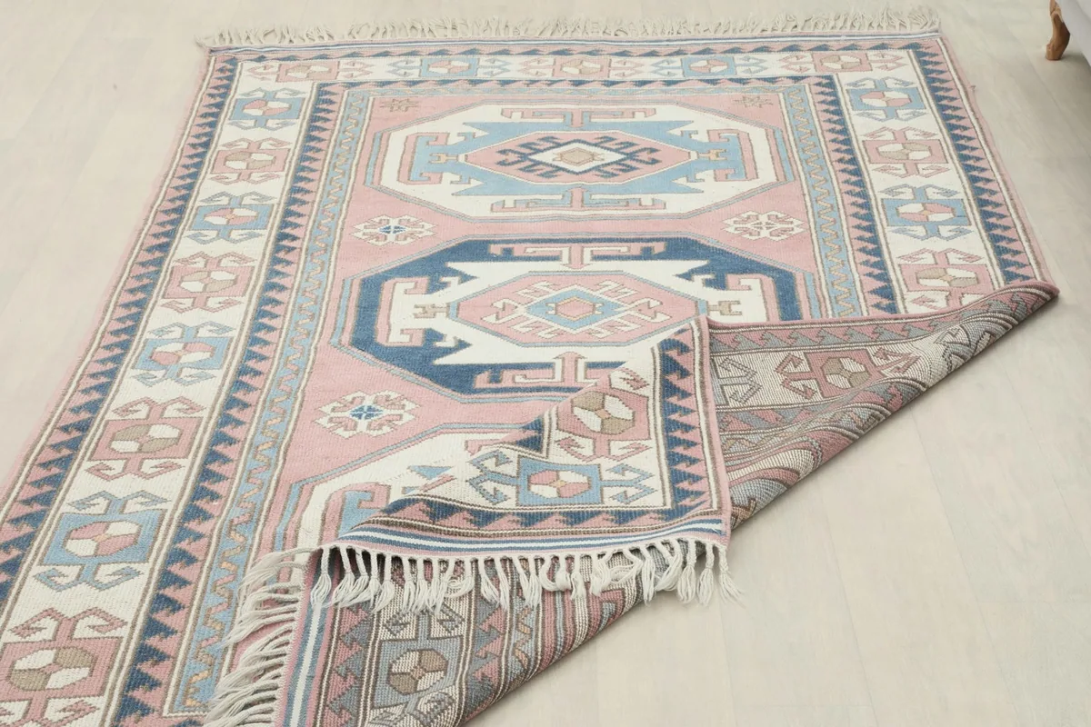 The Anatolian rug partially folded to show its flexibility and the reverse side