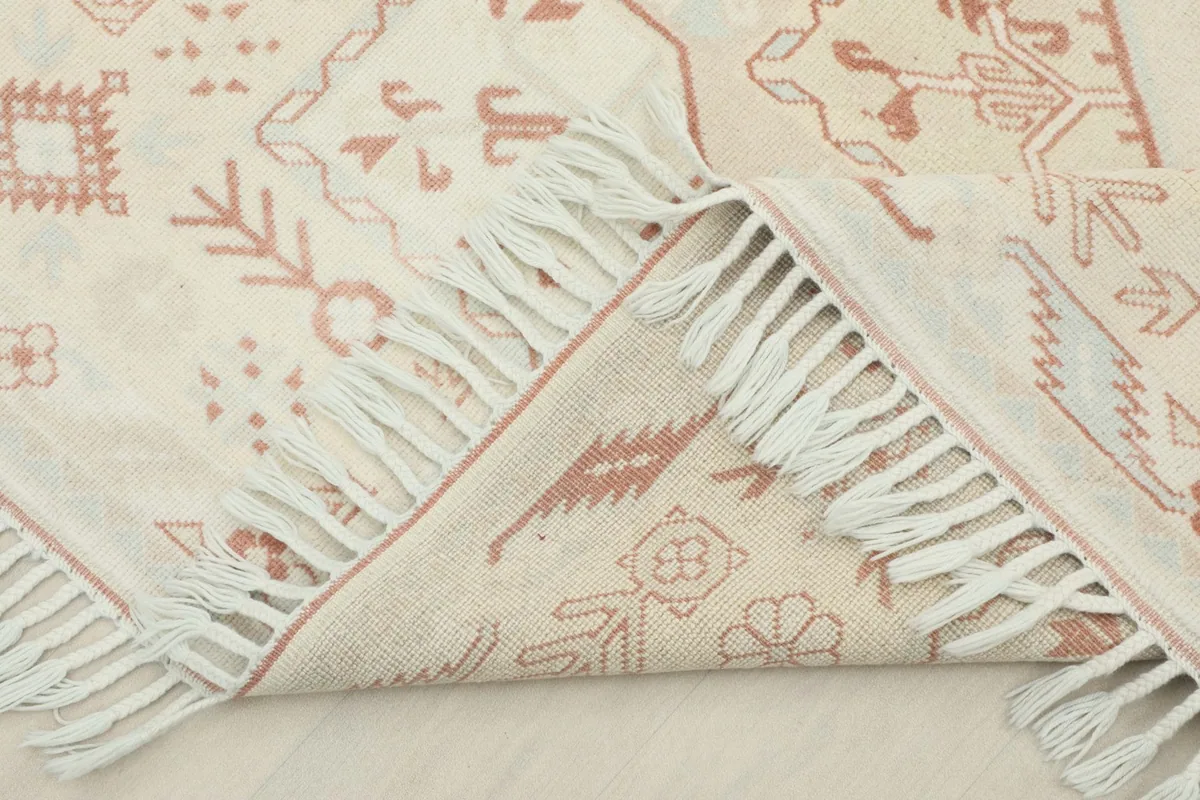 Folded rug showing the reverse side and the hand-knotted wool pile on cotton foundation