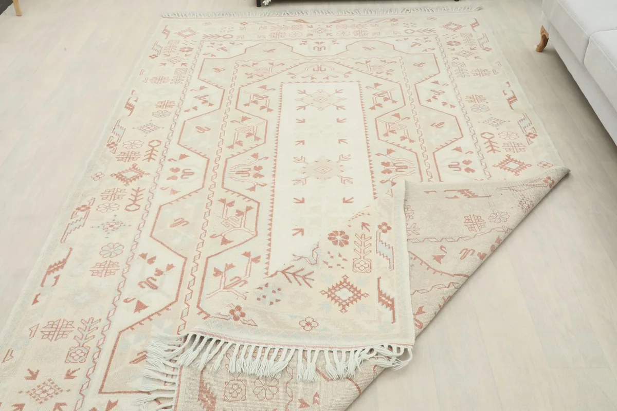 Rug partially folded to reveal the thickness and the back of the hand-knotted construction