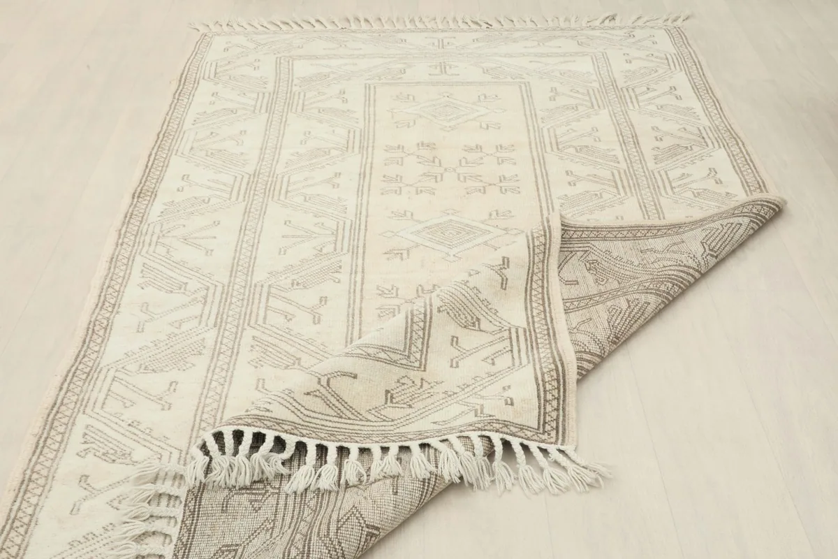 View of the rug's underside, revealing the hand-knotted construction