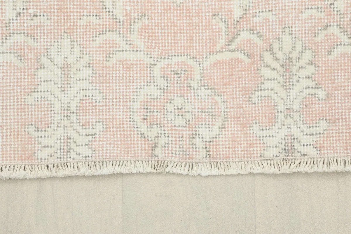 Close-up of the short, natural cotton fringe along the edge of the vintage Anatolian rug.