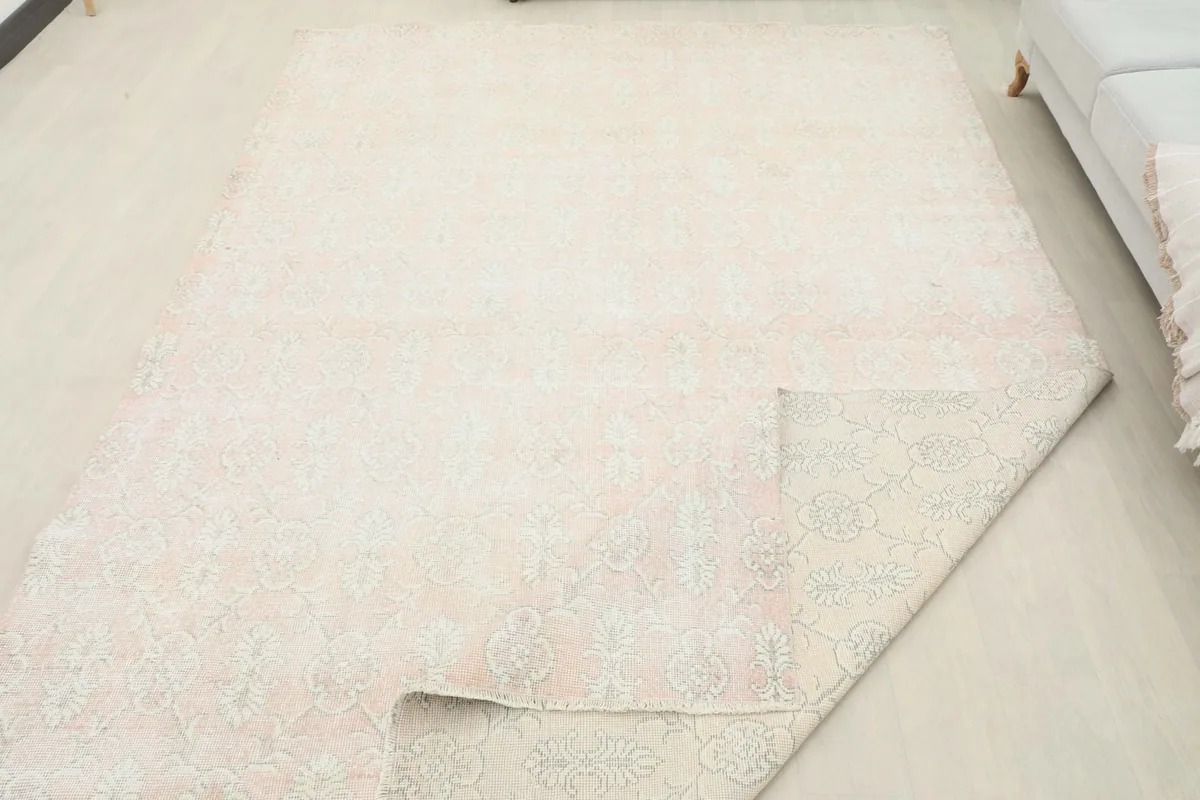 Rug corner folded to show the thickness and the back of the hand-knotted wool pile.
