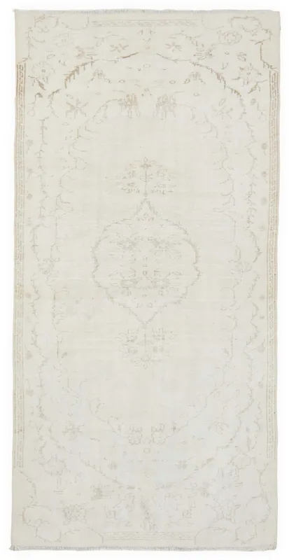 Full overhead view of the 4'5" x 9'1" vintage Anatolian rug with ivory and tan faded patterns.
