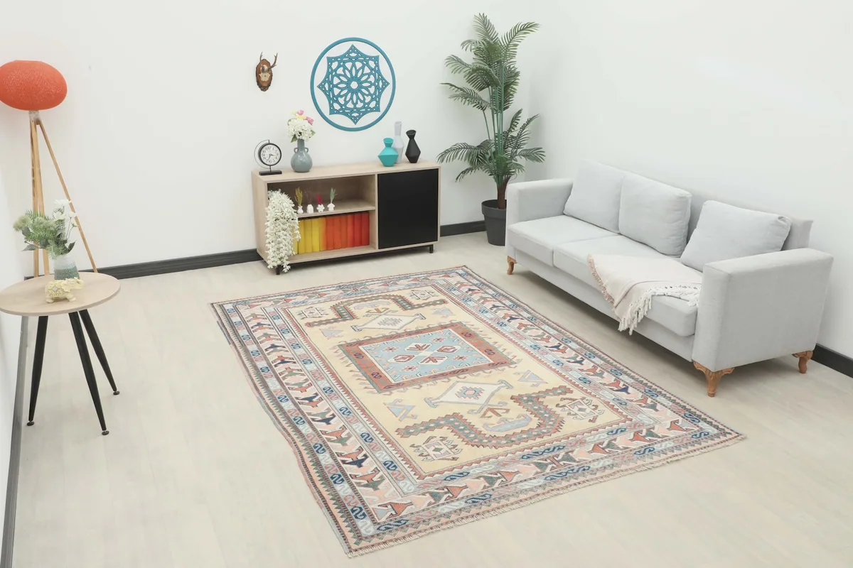 Vintage Anatolian rug displayed in a modern living room setting with a light gray sofa and wooden furniture.