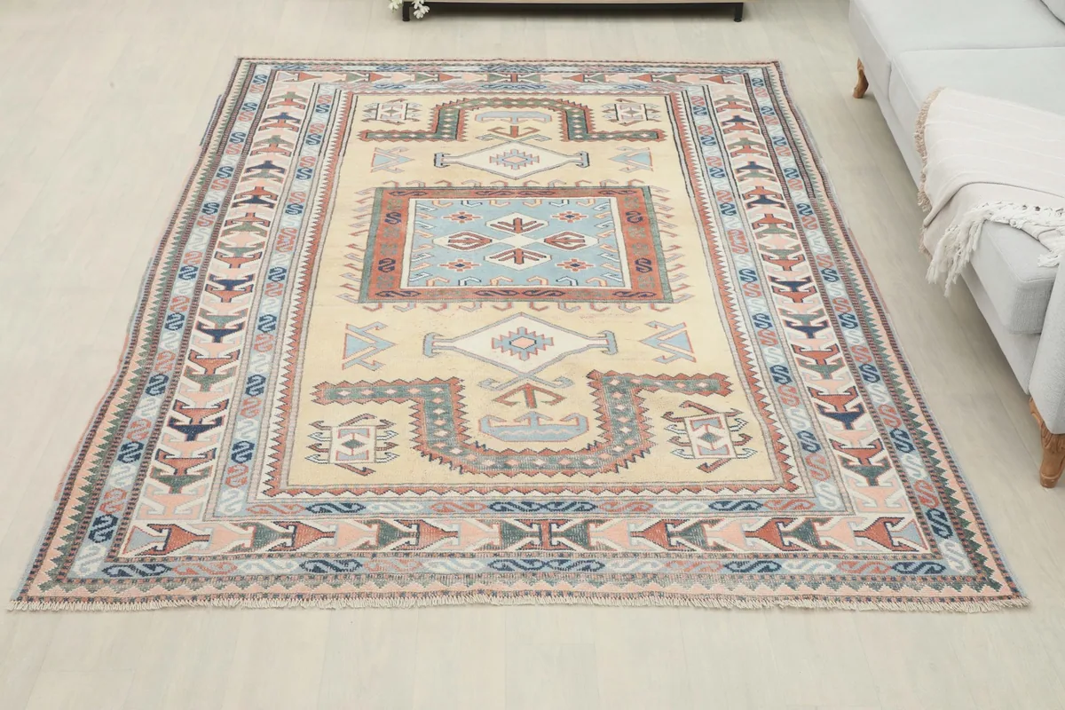 Full view of the rug in a room setting, positioned in front of a sofa, demonstrating its size and presence.