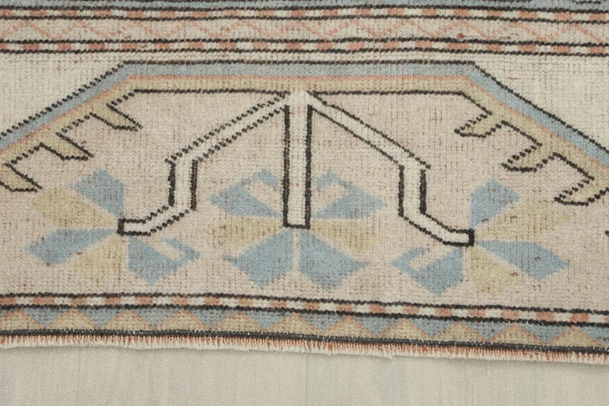Close-up of the low wool pile and the hand-knotted texture of the vintage Anatolian rug