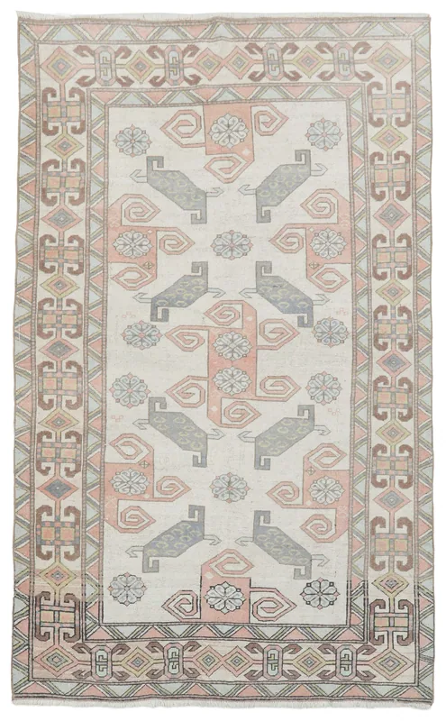Full top view of the 5'1" x 8'3" ivory and rose tribal geometric vintage Anatolian rug