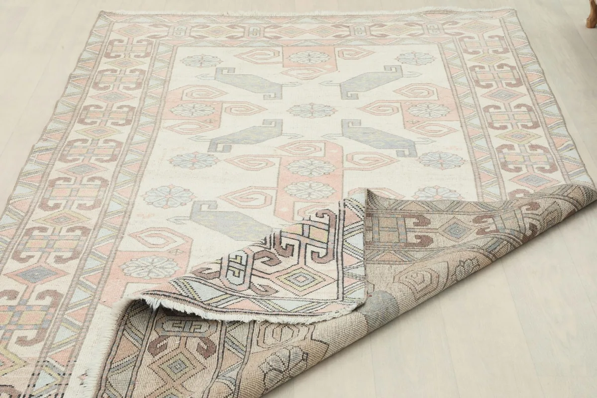 Partial view of the rug's reverse side, revealing the hand-knotted construction