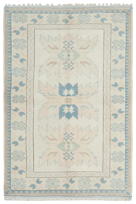 Full top view of the 6'2" x 9'2" ivory and blue vintage Anatolian rug with geometric patterns