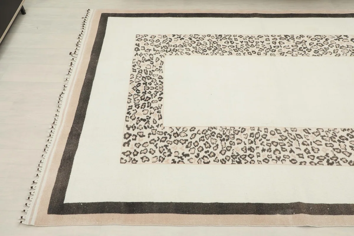 Angled view of the rug from the opposite side, showcasing the full border design.