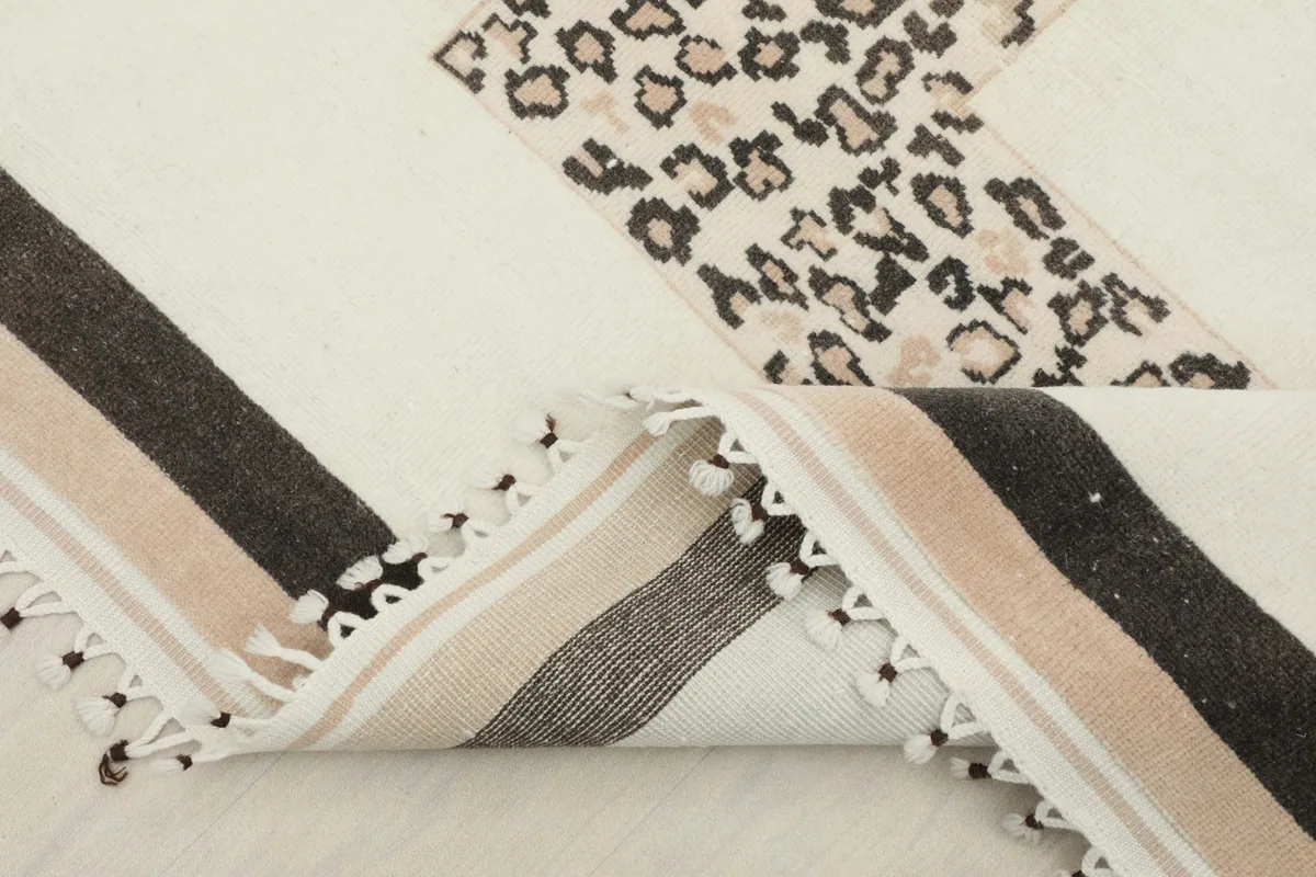Rug corner folded to reveal the construction and the reverse side.