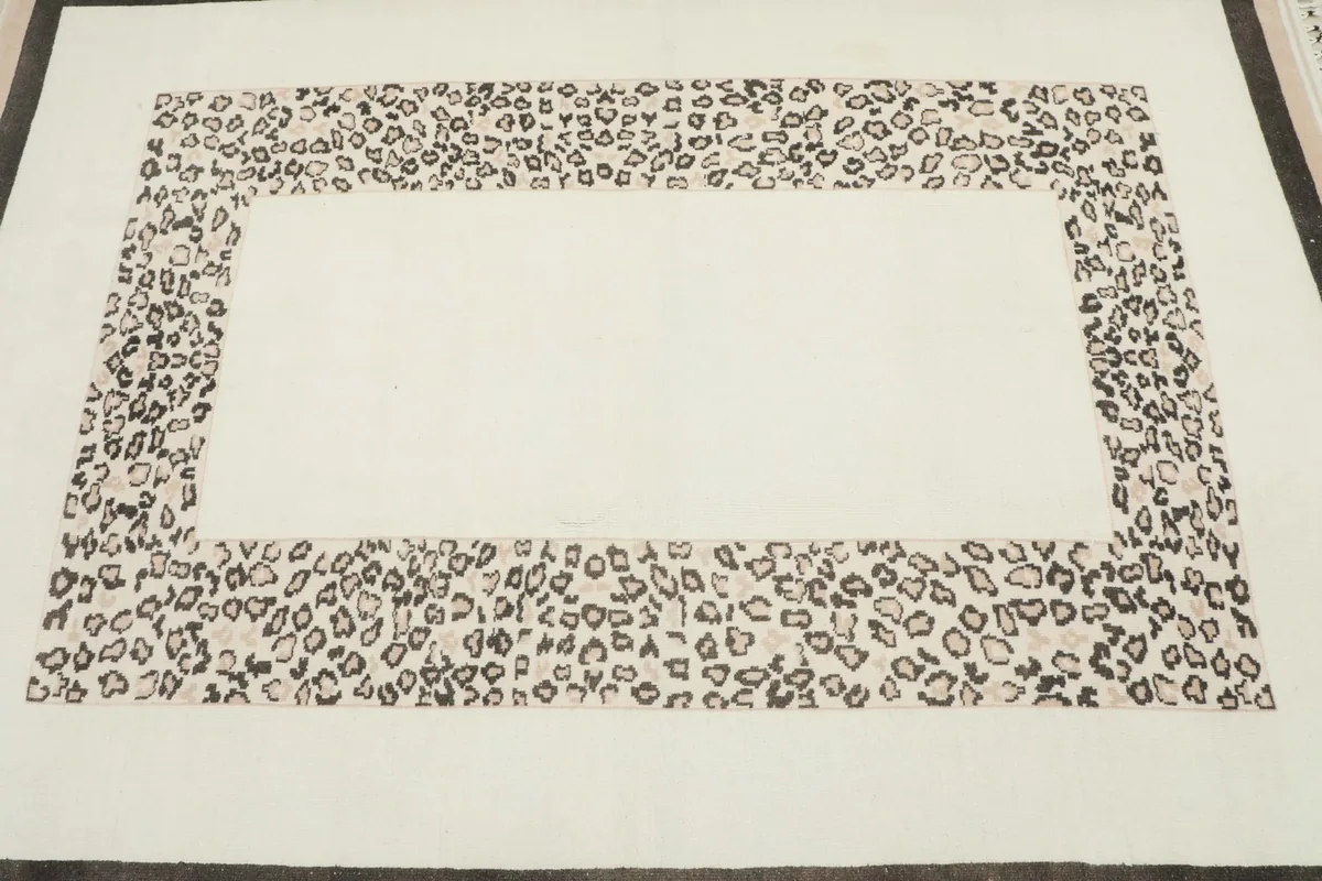Overhead detail of the rug's center and the leopard pattern frame.