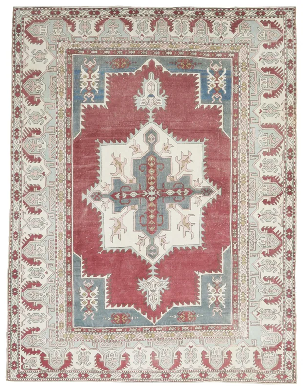 Full overhead view of the vintage Anatolian area rug with red, blue, and ivory medallion on a white background.