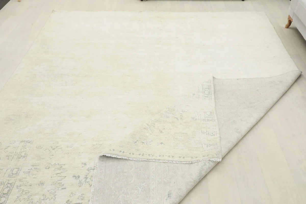 Larger view of the rug with a corner folded back, illustrating the thickness and construction