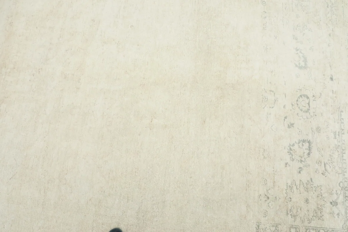 Close overhead view of the rug's surface, revealing the soft texture and faint patterns