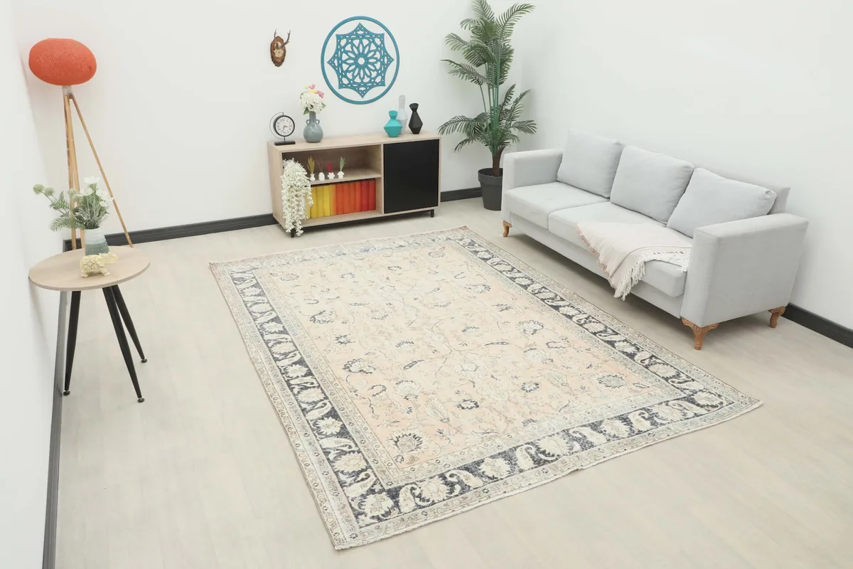 Vintage Anatolian rug displayed in a bright room with a light gray sofa and modern decor.
