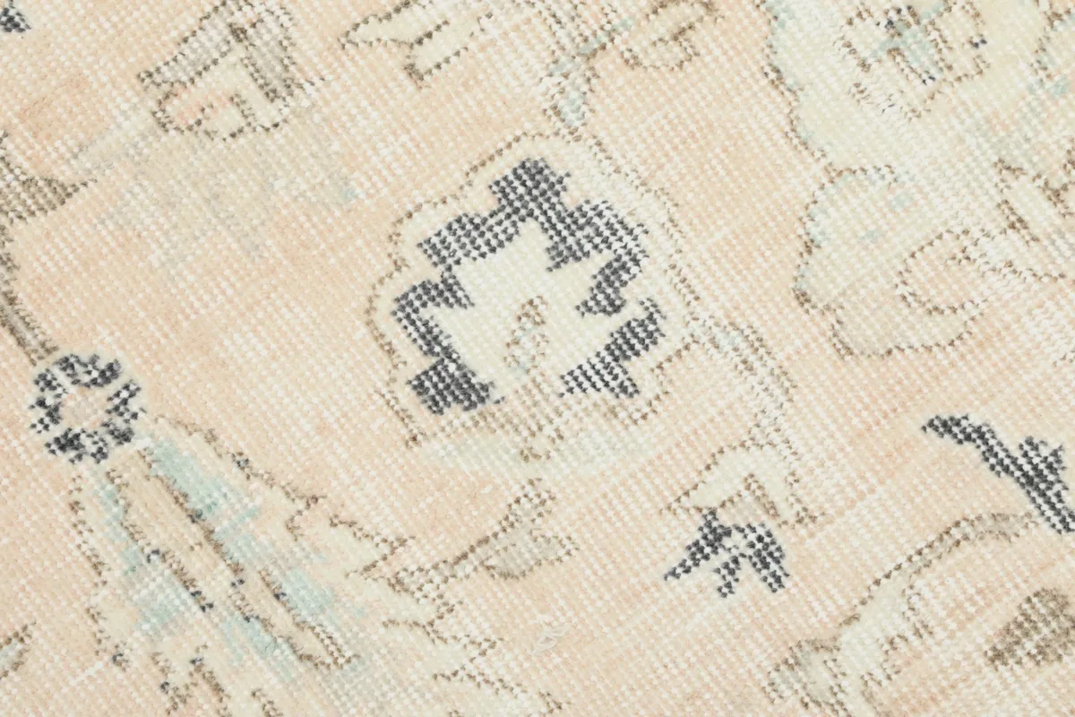 Detailed view of the rug's pile and individual knots, showing subtle color variations and wear.