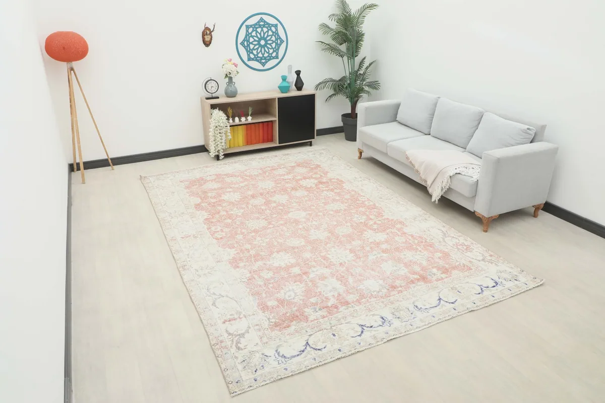 Rose and ivory floral Anatolian rug displayed in a modern living room setting