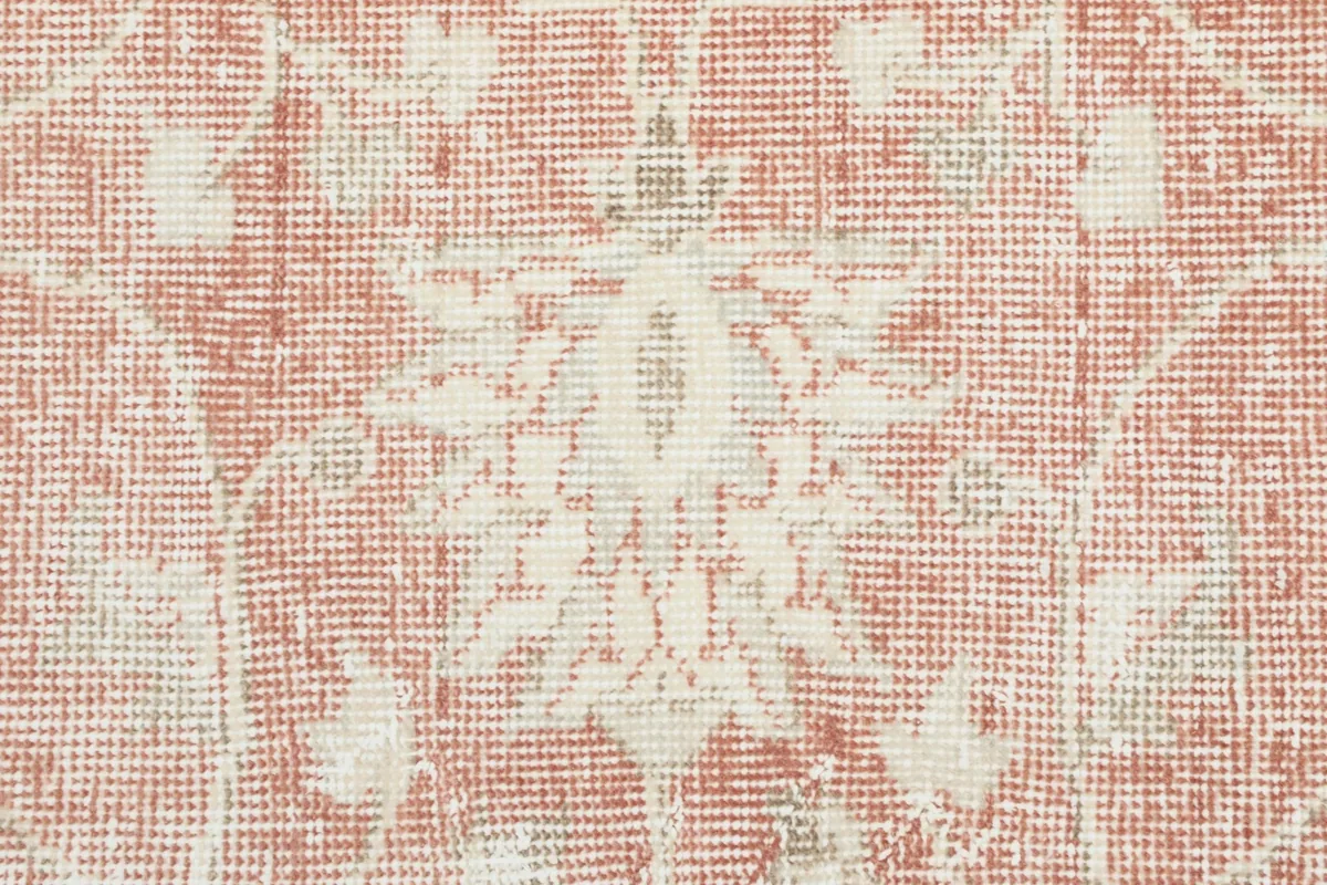 Extreme close-up of the rug's low wool pile, showing the hand-knotted texture