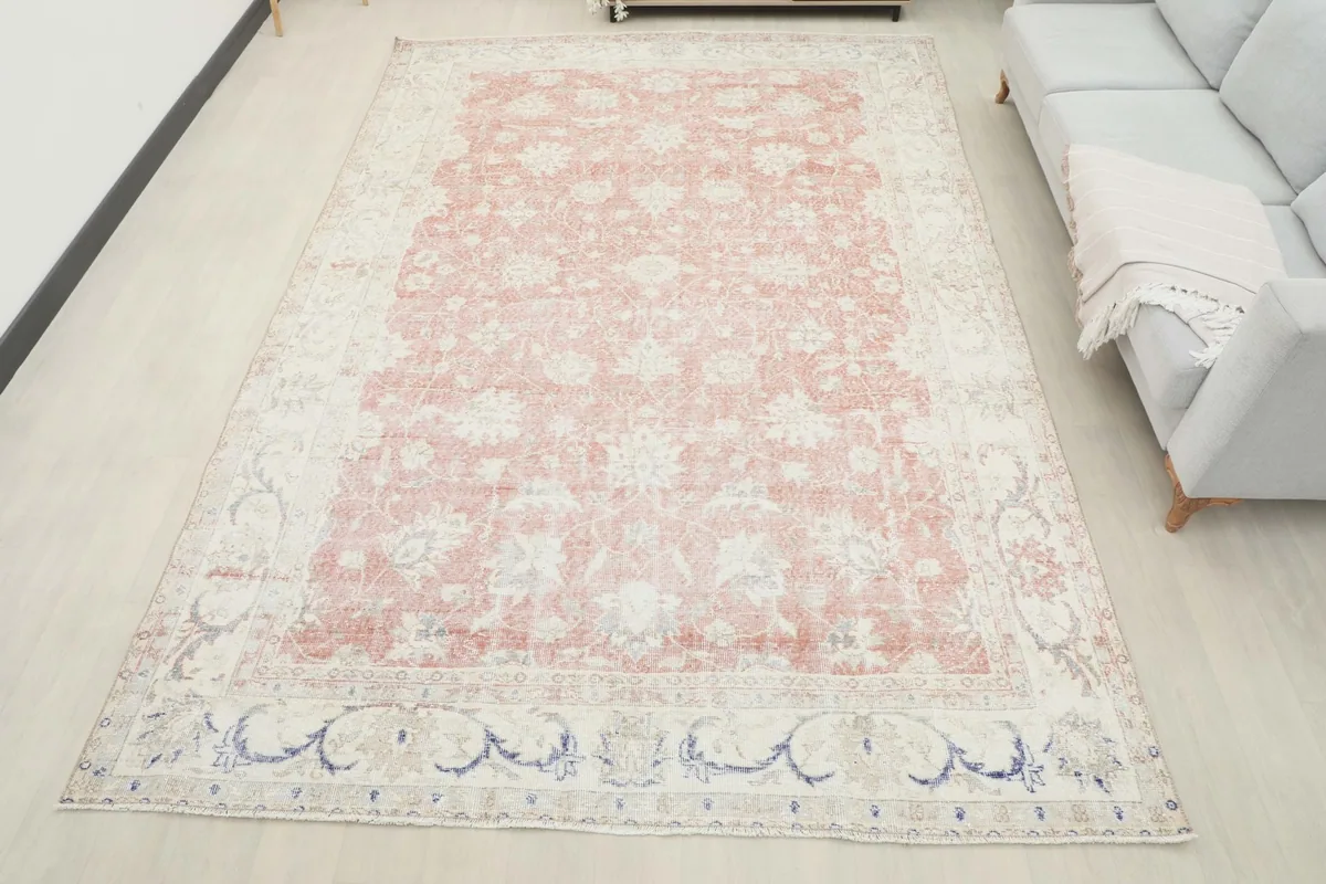 Overhead view of the large rose and ivory Anatolian rug in a room setting