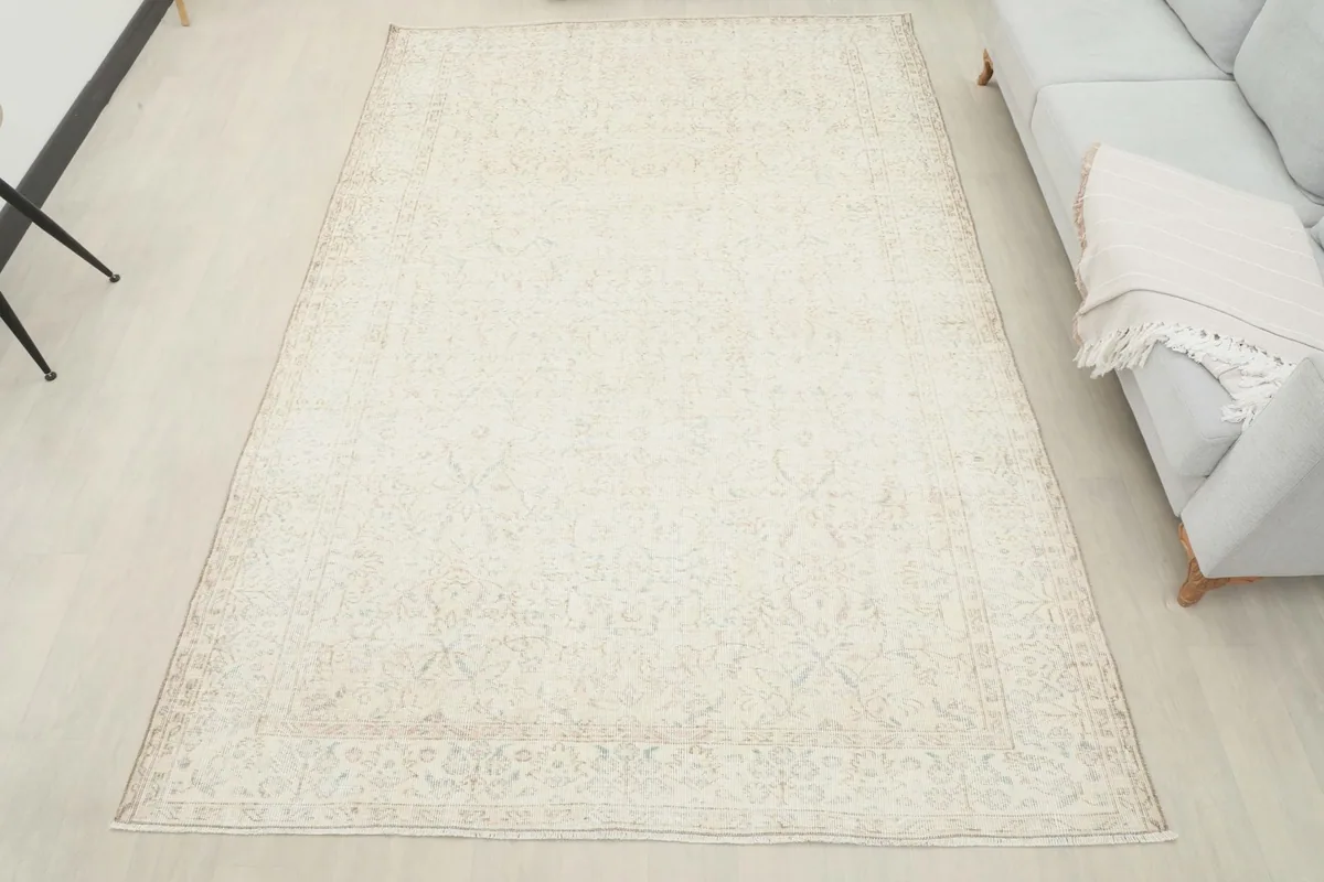 Full room view of the ivory vintage rug, providing a perspective of its large size in a living space
